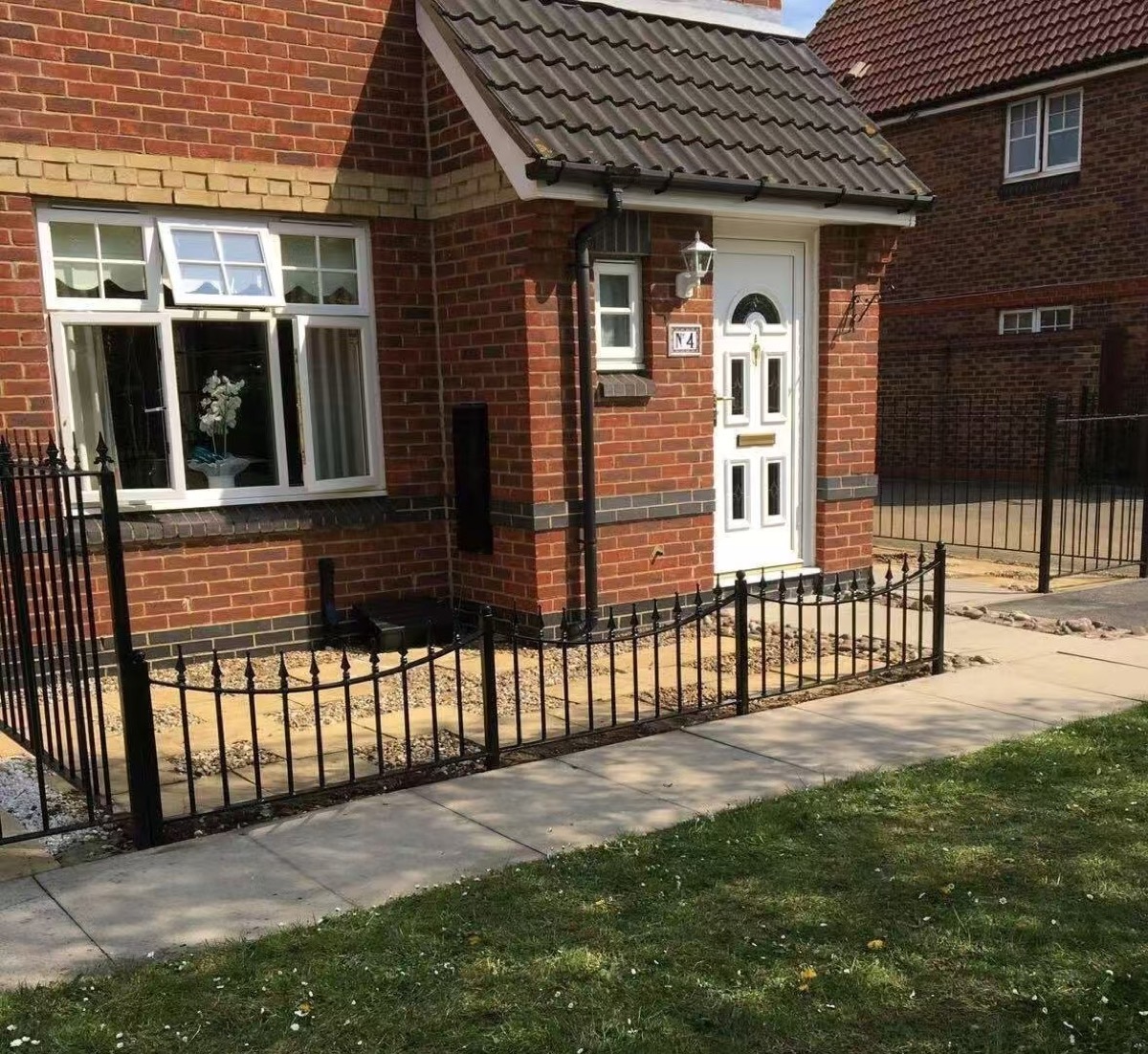 Decorative black garden fence at a residential front garden