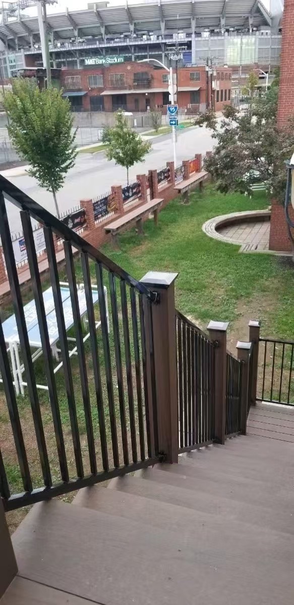 Narrow access gate positioned within a railing and stair layout