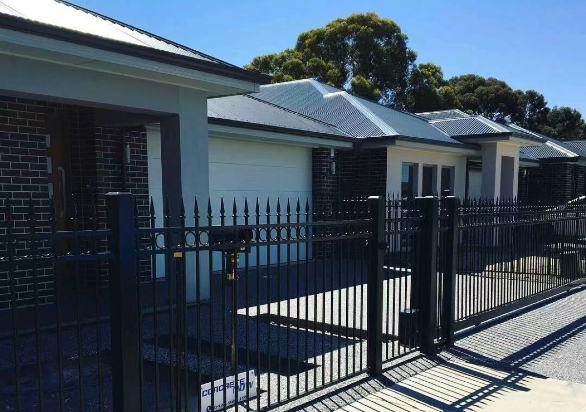 Residential aluminum garden gate integrated into a decorative boundary fence