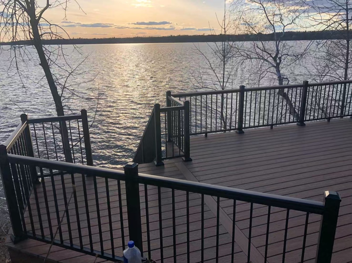 Black aluminum railing around a lakeside deck
