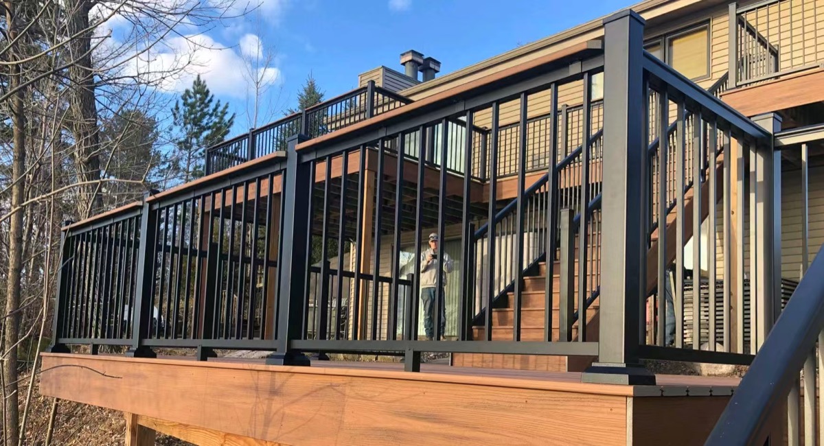 Black aluminum railing around a raised villa deck